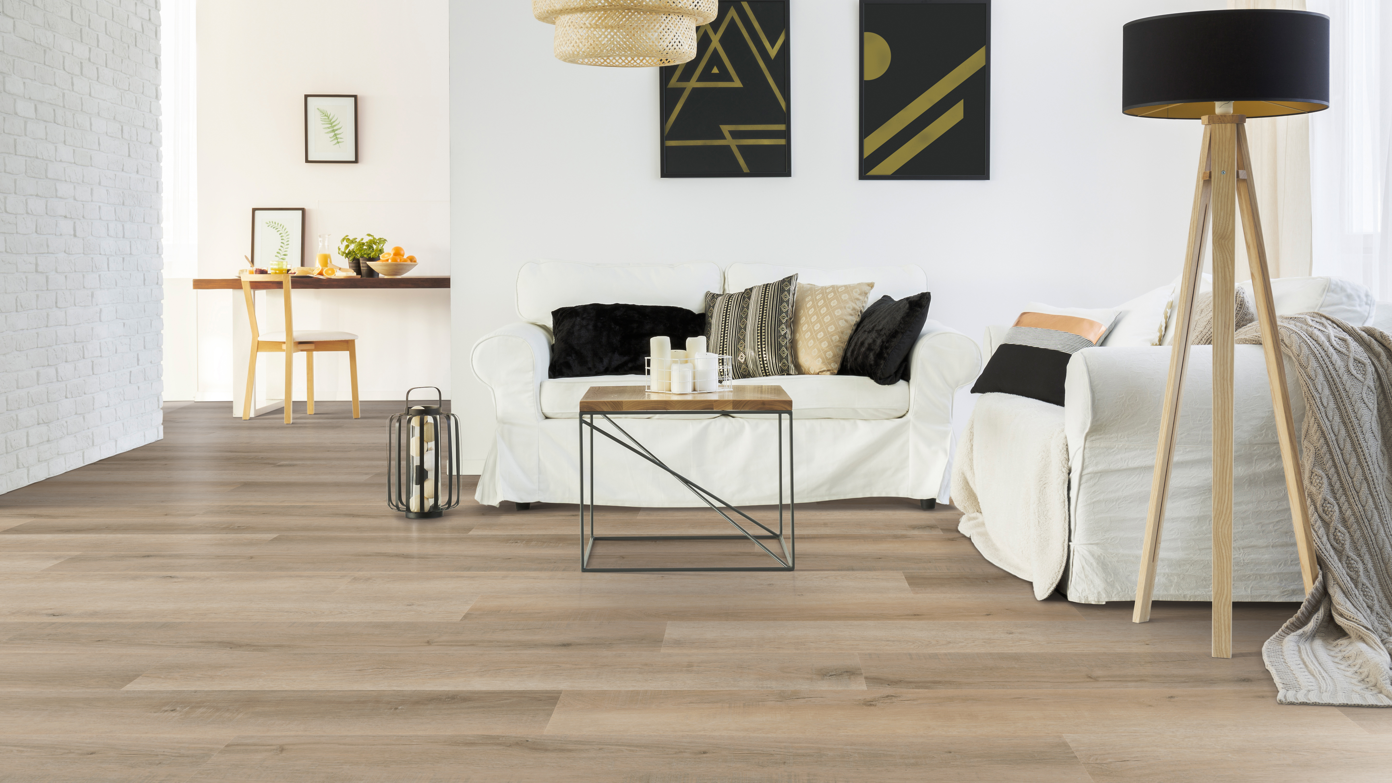 Luxury Vinyl Flooring installed with a white couch and black and tan pillows