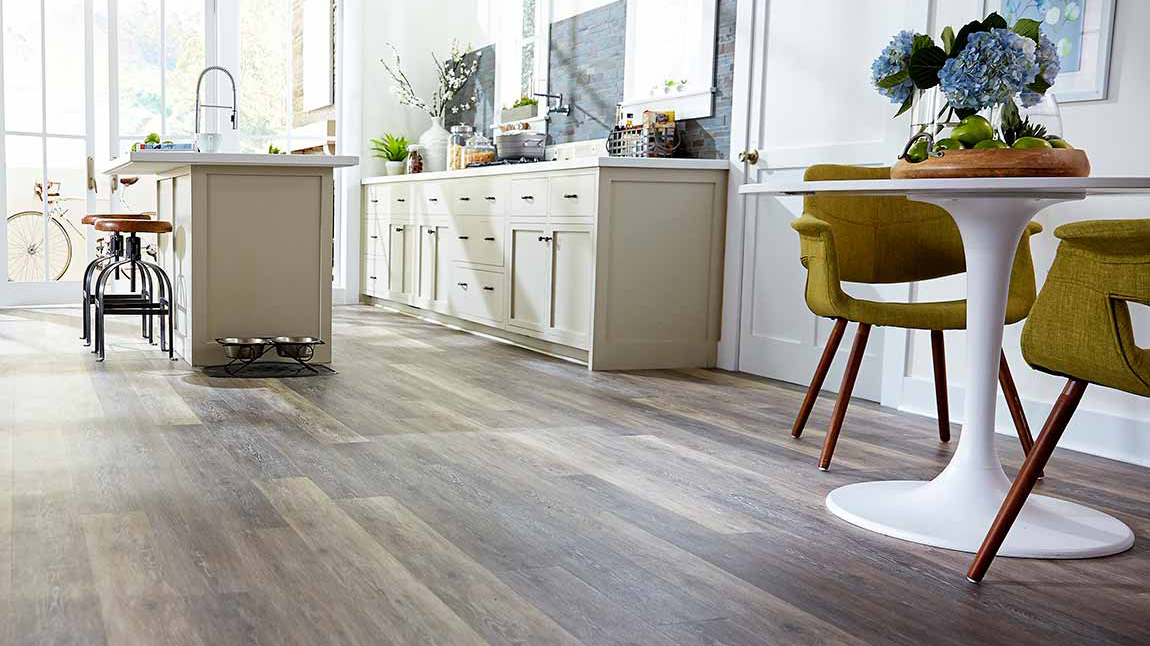 hardwood flooring with bar stools and green kitchen chairs 