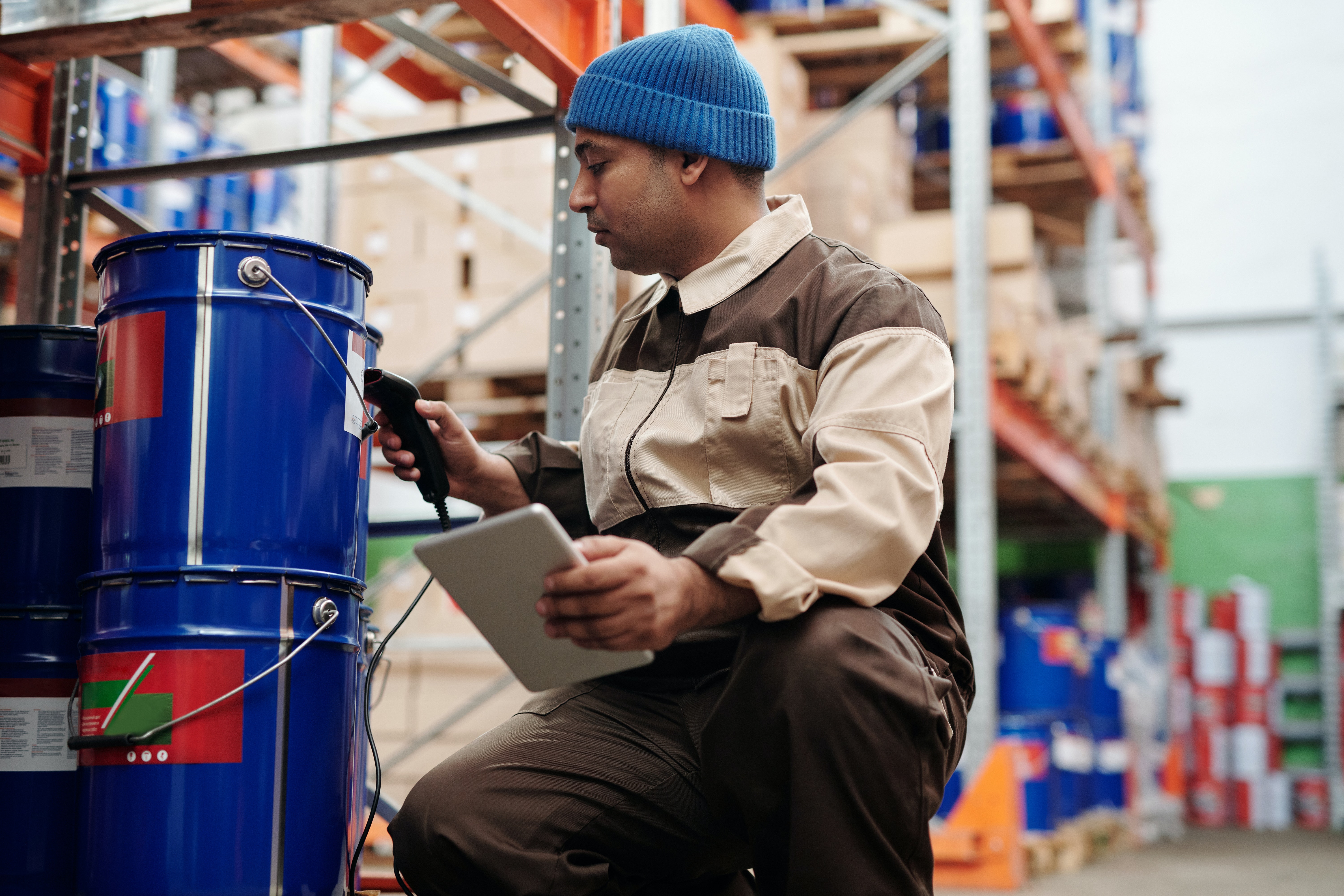 Stock Photo featuring flooring installer close up with paint in a warehouse.