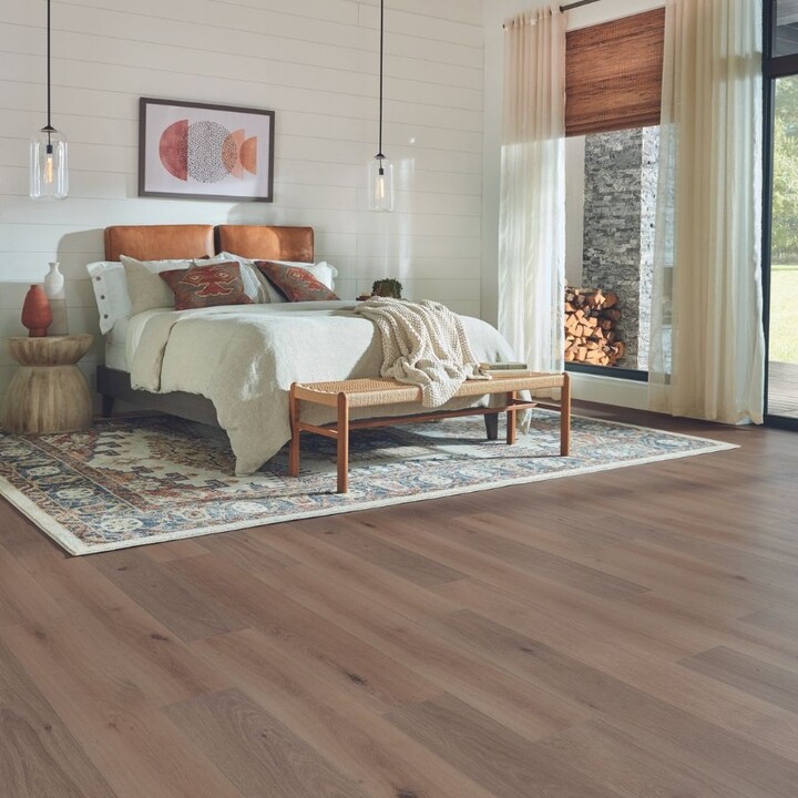 Laminate flooring in a bedroom with area rug